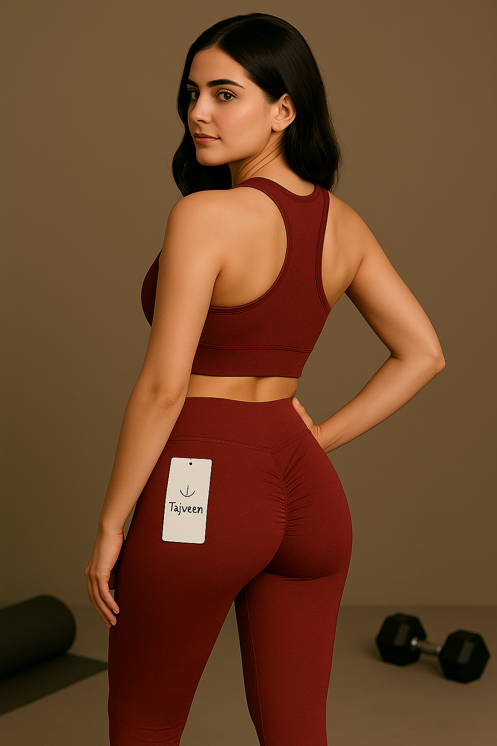 Woman wearing a maroon athletic outfit with a visible brand tag against a brown background