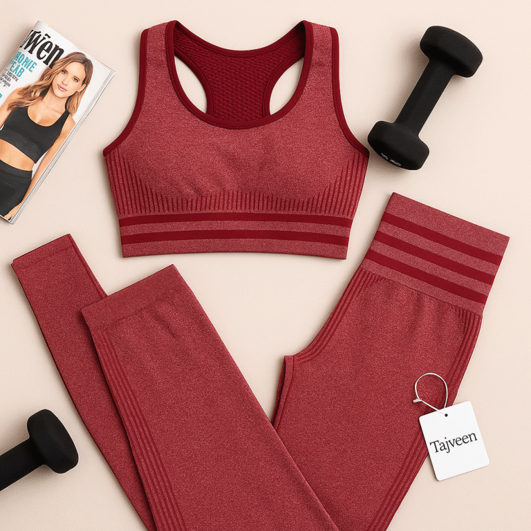 Red sports bra and leggings set with dumbbells and a magazine on a beige background